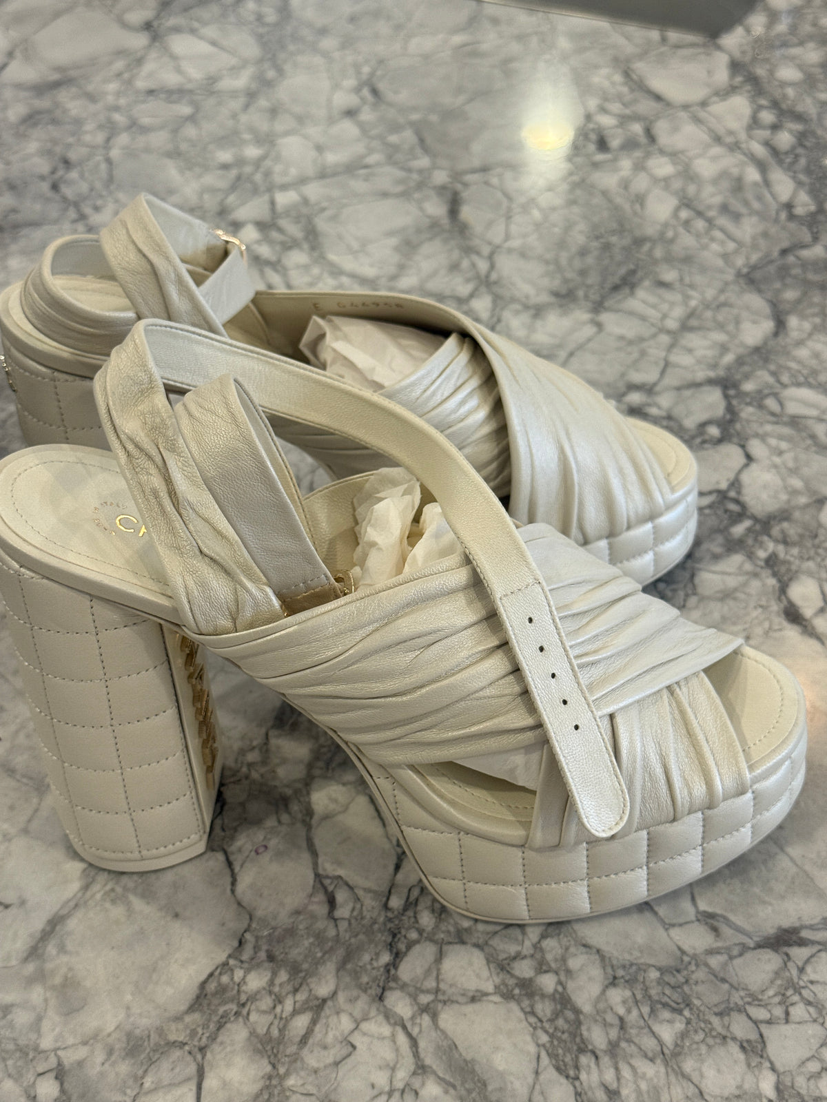 Ivory lambskin Chanel platform sandals with the quilted platform and block heel