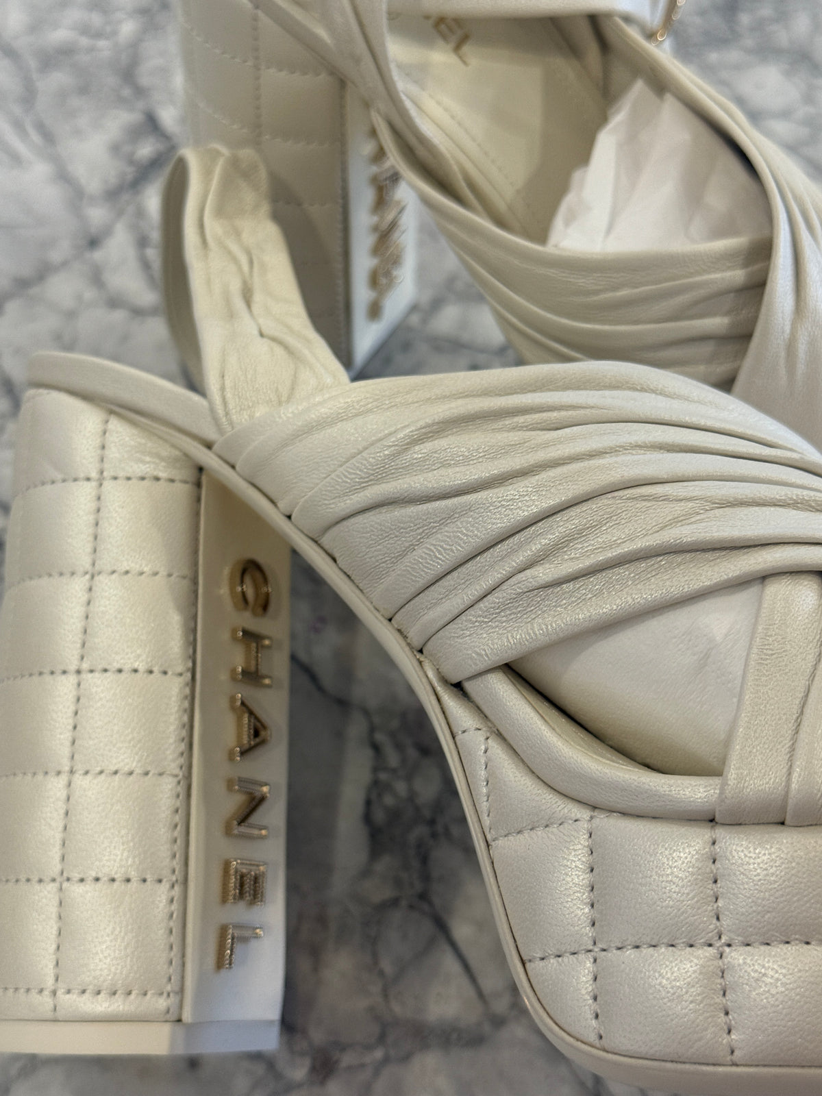 Ivory lambskin Chanel platform sandals with the quilted platform and block heel